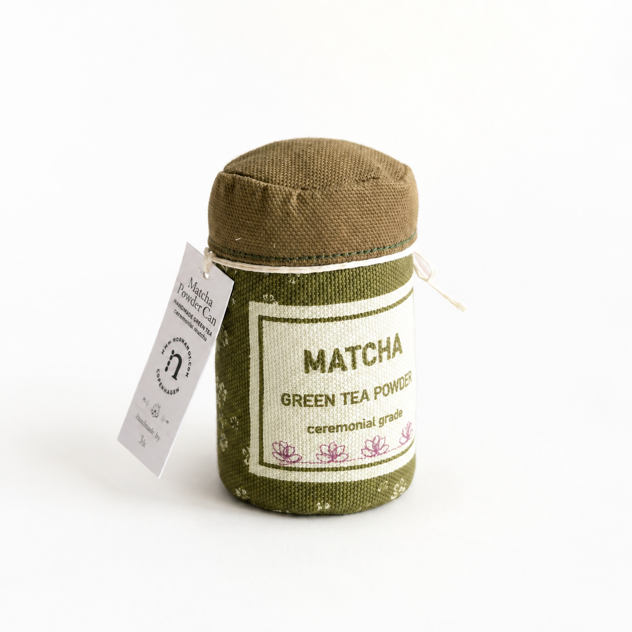 Fabric Matcha green tea powder container with label on a white background
