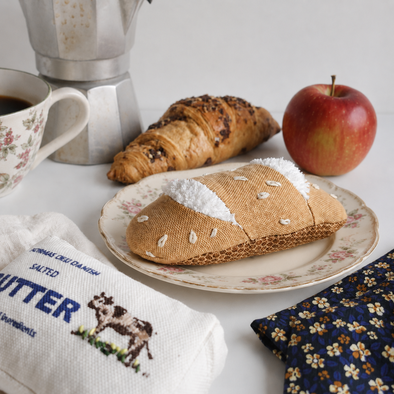 Pretend Play Food Breakfast setting with croissants, coffee, and an apple on a table.