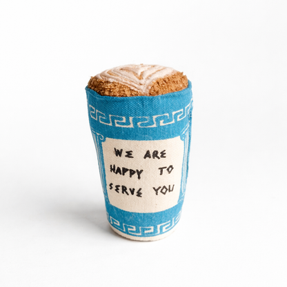 Handmade fabric Greek coffee cup  with blue-and-white print and soft latte art top on a clean white studio background.